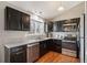 Modern kitchen featuring granite countertops, stainless steel appliances, dark cabinets and a window providing natural light at 200 N Holcomb St, Castle Rock, CO 80104