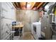 Functional laundry room with modern washer, dryer, utility sink and shelving at 200 N Holcomb St, Castle Rock, CO 80104