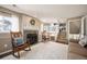 Cozy living room with fireplace, wooden rocking chairs and staircase to the upper level at 200 N Holcomb St, Castle Rock, CO 80104