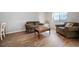 Cozy living area features wood laminate flooring, sofa, armchair, and a coffee table at 200 N Holcomb St, Castle Rock, CO 80104