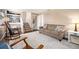 Comfortable living room showcasing a plush sofa, staircase and a decorative area rug at 200 N Holcomb St, Castle Rock, CO 80104