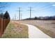 Scenic walking path beside a fence with power lines in the background, offering a tranquil outdoor space at 200 N Holcomb St, Castle Rock, CO 80104