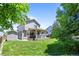 Spacious backyard features a covered patio and well-maintained lawn perfect for outdoor entertaining and relaxing at 20858 E Progress Ave, Centennial, CO 80015