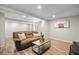 Cozy finished basement area with neutral walls, a large couch, and modern flooring at 20858 E Progress Ave, Centennial, CO 80015