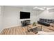 Finished basement with a mounted TV, modern flooring, and contemporary furnishings at 20858 E Progress Ave, Centennial, CO 80015