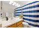 Bathroom featuring vanity, sink, mirror, toilet and shower with striped curtain at 20858 E Progress Ave, Centennial, CO 80015