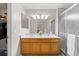 Bright bathroom features double sinks, oak cabinets, and large mirror at 20858 E Progress Ave, Centennial, CO 80015