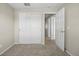 Neutral bedroom with large double door closet, carpet, and access to the hallway at 20858 E Progress Ave, Centennial, CO 80015
