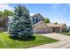 Charming two-story home with a well-manicured lawn and mature blue spruce at 20858 E Progress Ave, Centennial, CO 80015