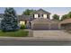 Charming two-story home with a brick-accented facade and a spacious three-car garage at 20858 E Progress Ave, Centennial, CO 80015