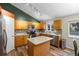 Modern kitchen with stainless steel appliances, center island, and mosaic tile backsplash at 20858 E Progress Ave, Centennial, CO 80015