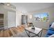 Bright living room with hardwood floors, modern decor, and large window offering natural light at 20858 E Progress Ave, Centennial, CO 80015