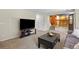 Spacious living room featuring neutral carpets, furniture, and an entertainment center at 20858 E Progress Ave, Centennial, CO 80015