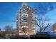 Evening view of a multi-story residential building with city lights at 130 N Pearl St # 404, Denver, CO 80203