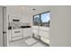 Bright kitchen features white appliances and a window overlooking the city at 130 N Pearl St # 404, Denver, CO 80203