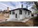 Exterior rear view featuring freshly painted white brick with updated windows and door and new concrete at 4267 Federal Blvd, Denver, CO 80211