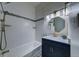 Beautiful bathroom with a tub, sleek vanity, updated fixtures, and stylish blue backsplash at 4267 Federal Blvd, Denver, CO 80211