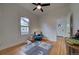 Bedroom with natural light, ceiling fan, hardwood floors and an accent chair by the window at 4267 Federal Blvd, Denver, CO 80211