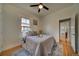 Bright bedroom featuring hardwood floors, ceiling fan, and a comfortable bed by the window at 4267 Federal Blvd, Denver, CO 80211