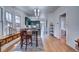 Open dining room with hardwood floors, a large window seat, and views into the kitchen at 4267 Federal Blvd, Denver, CO 80211