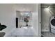 Hallway view with decorative floors, with view to the washer and dryer behind an open door at 4267 Federal Blvd, Denver, CO 80211