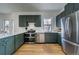 Bright kitchen features modern green cabinets, stainless appliances, and an efficient layout at 4267 Federal Blvd, Denver, CO 80211