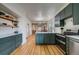 Modern kitchen featuring custom cabinets, quartz counters, stainless appliances, and a seamless open design at 4267 Federal Blvd, Denver, CO 80211