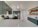Bright kitchen featuring quartz counters, modern cabinetry, stainless appliances, and open shelving at 4267 Federal Blvd, Denver, CO 80211