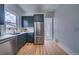 Updated kitchen featuring green cabinets, stainless appliances, with convenient access to outdoor views at 4267 Federal Blvd, Denver, CO 80211