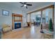 Spacious living room with hardwood floors, decorative fireplace, and an open floor plan at 4267 Federal Blvd, Denver, CO 80211