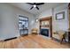 Cozy living room with decorative fireplace, hardwood floors, and natural light at 4267 Federal Blvd, Denver, CO 80211