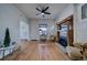 Bright living room with hardwood floors, a ceiling fan, and a decorative fireplace at 4267 Federal Blvd, Denver, CO 80211
