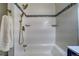 Close-up of the stand up shower with gold fixtures and white tiling at 4267 Federal Blvd, Denver, CO 80211