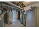 Functional utility room features a hot water heater, water filtration, and exposed beams above at 4267 Federal Blvd, Denver, CO 80211