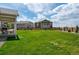 Lush backyard with a covered patio and ample green space, perfect for outdoor living and gatherings at 944 Alpine Ridge St, Erie, CO 80516