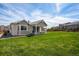 Spacious backyard with a covered patio, providing ample space for outdoor entertainment and activities at 944 Alpine Ridge St, Erie, CO 80516