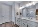 Bright bathroom featuring a double vanity with modern fixtures, a glass-enclosed shower, and ample lighting at 944 Alpine Ridge St, Erie, CO 80516