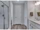 Bright bathroom features a glass enclosed shower and a single sink vanity at 944 Alpine Ridge St, Erie, CO 80516