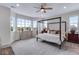 Spacious bedroom with a four-poster bed, bright windows, and ample natural light at 944 Alpine Ridge St, Erie, CO 80516