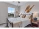Bedroom with window and snowshoes hanging above the bed at 944 Alpine Ridge St, Erie, CO 80516