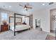 Bedroom featuring neutral carpet and canopy bed, showcasing a tranquil retreat within the home at 944 Alpine Ridge St, Erie, CO 80516