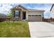 Charming home with stone accents, a well-manicured lawn, and a two-car garage at 944 Alpine Ridge St, Erie, CO 80516