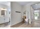 Hallway with bathroom view, coat rack and decorative mirror at 944 Alpine Ridge St, Erie, CO 80516