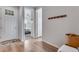 Hallway featuring hardwood floors and view into the main bedroom at 944 Alpine Ridge St, Erie, CO 80516
