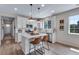 Bright kitchen boasting white cabinets, an island with bar seating, and hardwood floors at 944 Alpine Ridge St, Erie, CO 80516