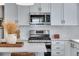 Close-up of a kitchen with quartz counters, stainless appliances, and modern fixtures at 944 Alpine Ridge St, Erie, CO 80516
