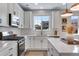 Stylish kitchen showcasing ample counter space, stainless appliances, and modern pendant lights at 944 Alpine Ridge St, Erie, CO 80516
