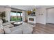 Bright living room with fireplace, TV, stylish furniture and sliding glass door to backyard at 944 Alpine Ridge St, Erie, CO 80516