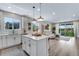 Open-concept kitchen flowing into a cozy living room with a sliding glass door and sofa at 944 Alpine Ridge St, Erie, CO 80516