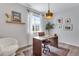 Bright office with a work desk, stylish chair, floating shelves and a large window at 944 Alpine Ridge St, Erie, CO 80516